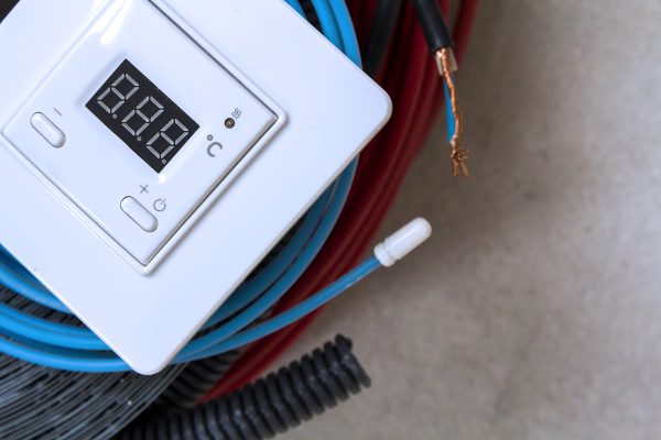 Heating floor system wires, cables and control panel. Renovation and construction concept. Comfort house.